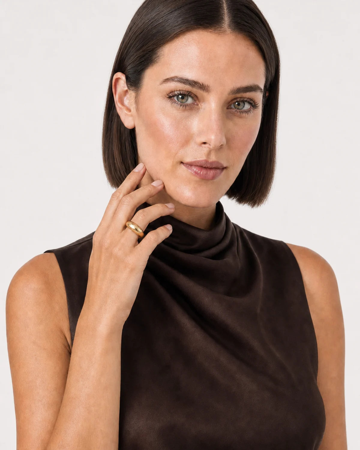 Australian model aged 25 to 28 wearing the Lune dome ring in a pale dove-grey studio
