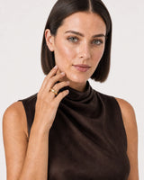 Australian model aged 25 to 28 wearing the Lune dome ring in a pale dove-grey studio