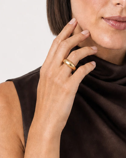 Clean hand close-up of the Lune polished gold dome ring