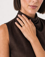 Human-scale close view of the Lune dome ring worn beside the model's collarbone
