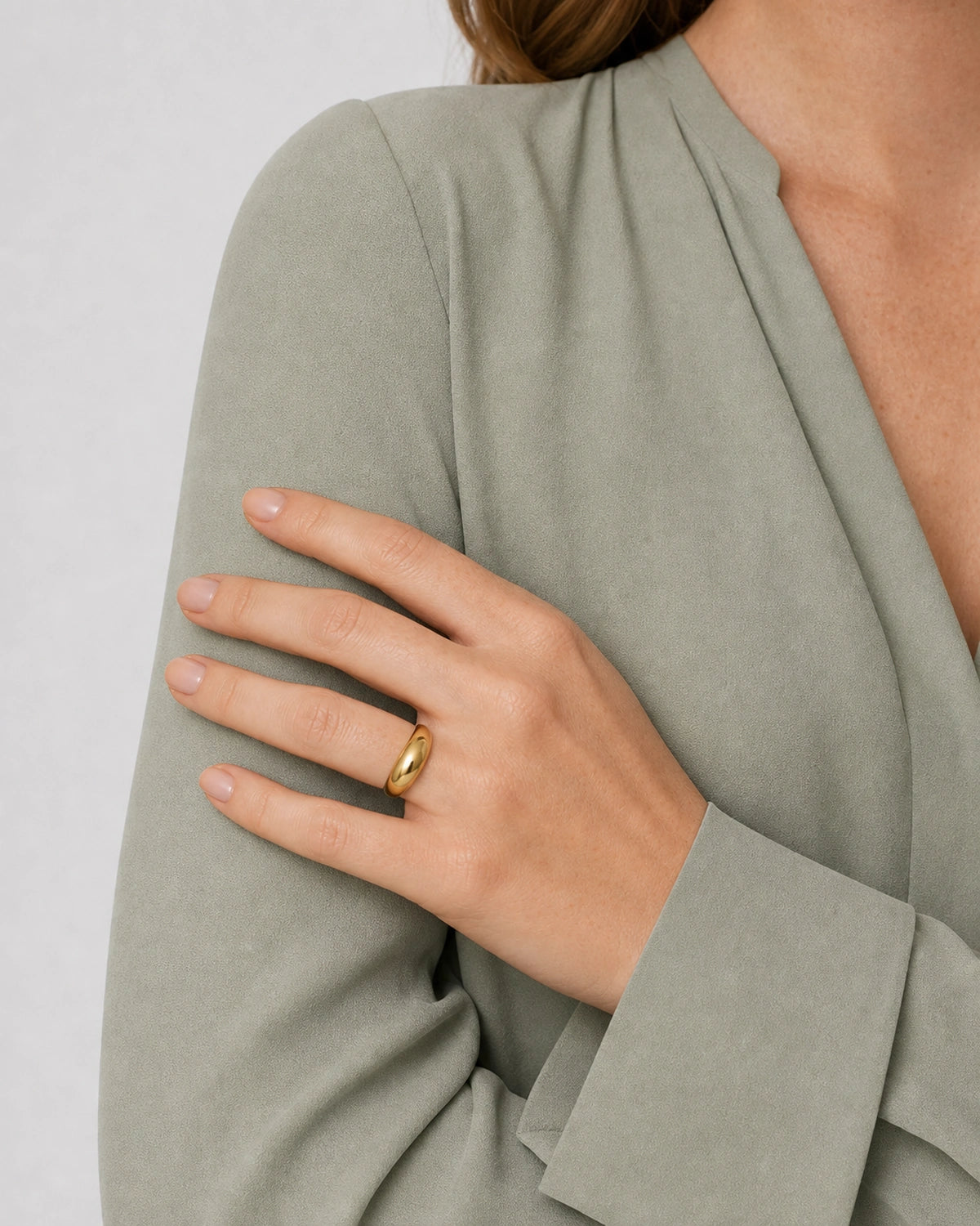 Lune gold dome ring shown in a close crossed-cuff wearing pose