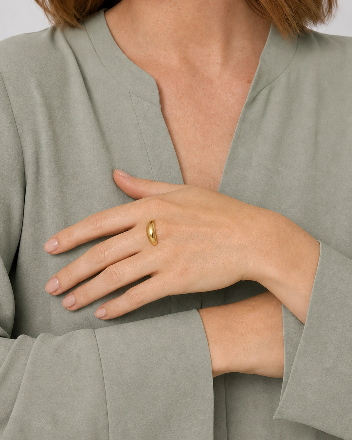 Lune gold dome ring worn palm-down across the opposite wrist