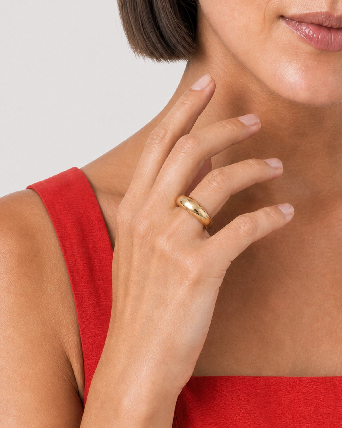 Close wearing view of the Lune ring's smooth rounded gold dome