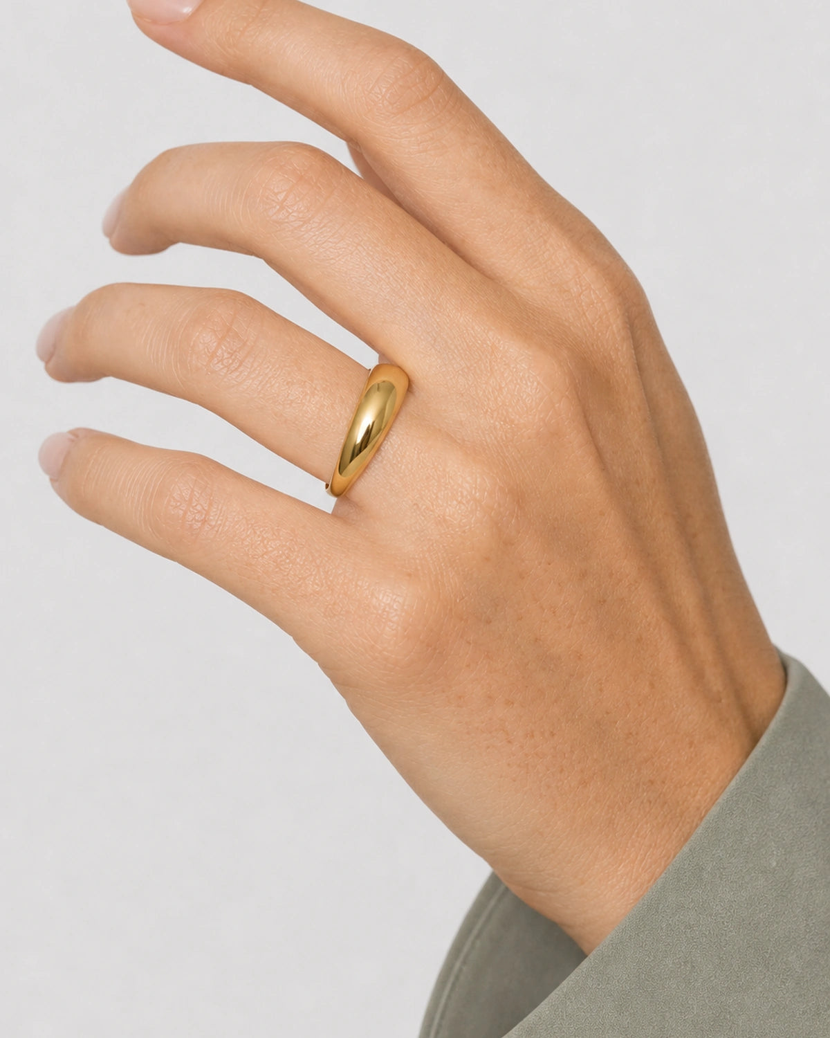 Complete worn macro of the Lune gold dome ring at true human scale