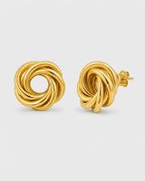 Lyra gold circle knot stud earrings on warm soft ivory