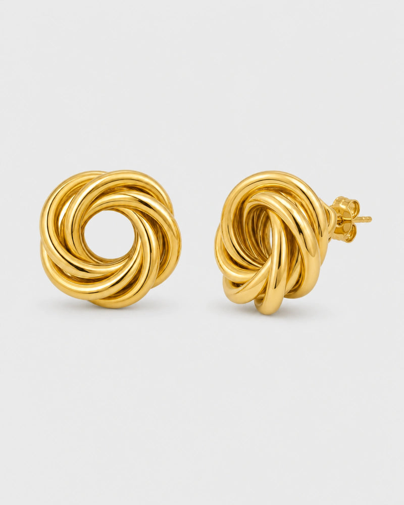 Lyra gold circle knot stud earrings on warm soft ivory