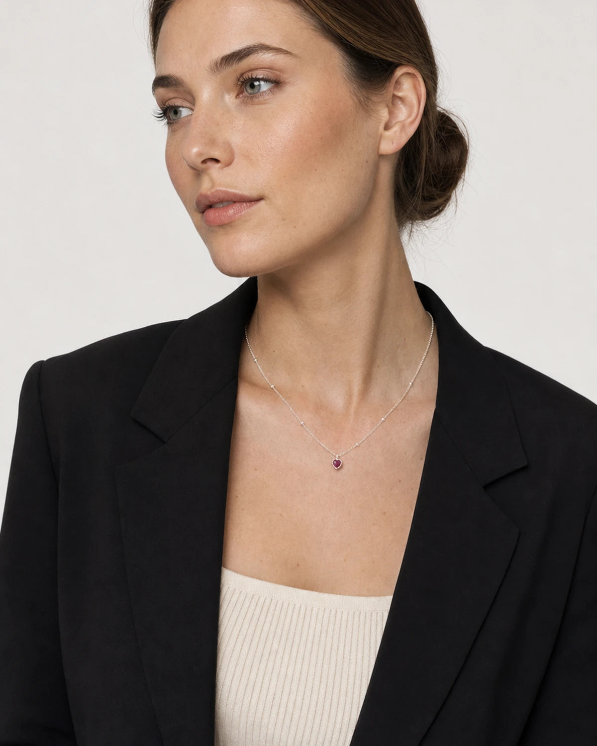 British model wearing the Maëlle silver crimson heart necklace