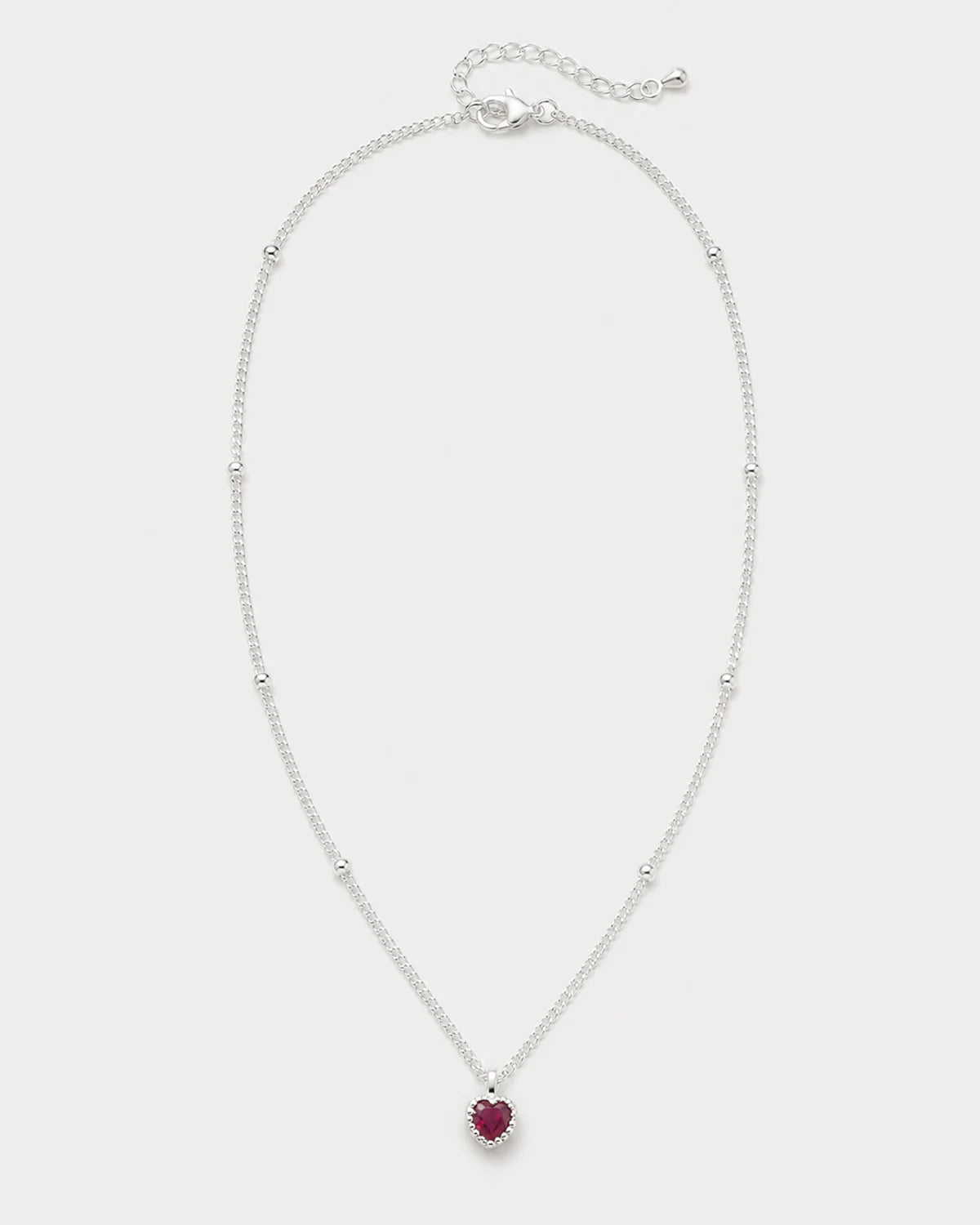 Maëlle silver crimson heart station necklace on seamless pale neutral grey
