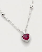 Macro of the faceted crimson heart, clear halo and silver Maëlle station chain