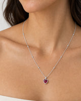 Eye-free frontal portrait of Elise wearing the silver Maëlle crimson heart necklace