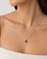 Eye-free right profile of Elise wearing the silver Maëlle crimson heart pendant