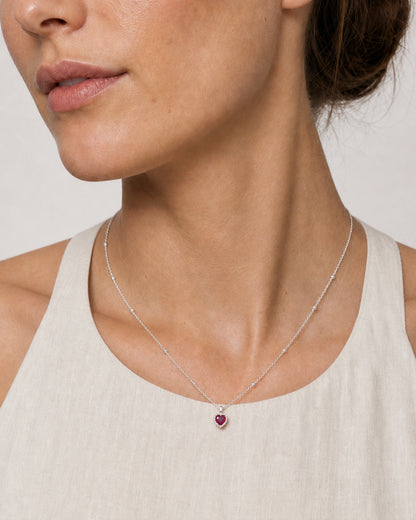 Close wearing view of the Maëlle silver station chain and crimson heart