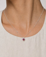 Extreme on-body macro of the Maëlle faceted crimson heart and clear halo