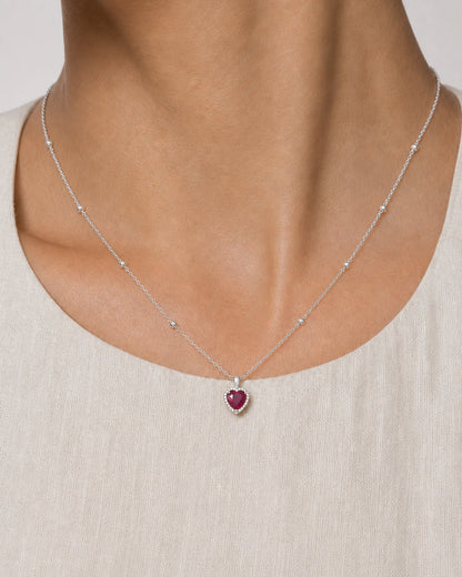 Extreme on-body macro of the Maëlle faceted crimson heart and clear halo