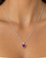 Extreme worn macro of the Maëlle faceted crimson heart, clear halo and station chain