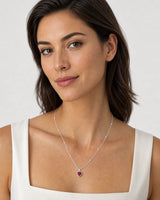 Model wearing the Maelle silver crimson heart station necklace on dove grey