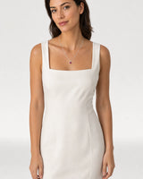 Waist-up ivory dress portrait featuring the Maelle crimson heart necklace