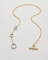 Marais mixed-metal lariat shown unfastened in an alternate studio arrangement