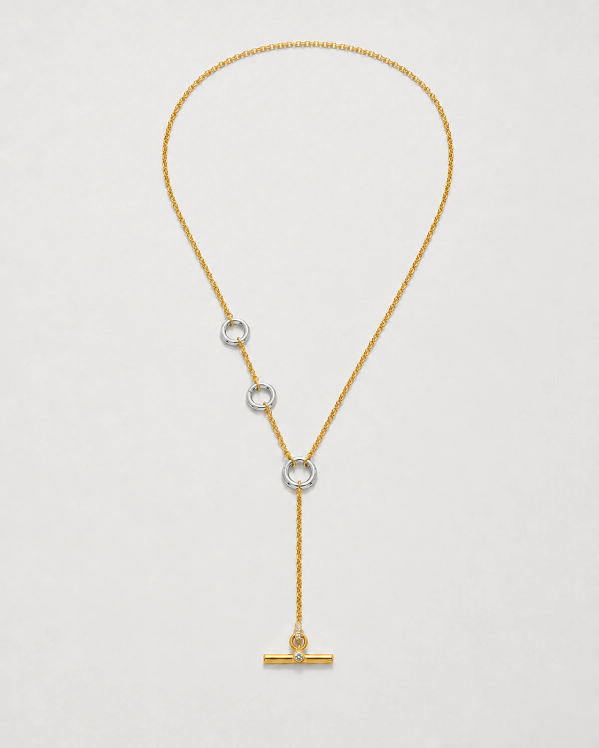 Marais mixed-metal crystal lariat necklace on seamless pale neutral grey