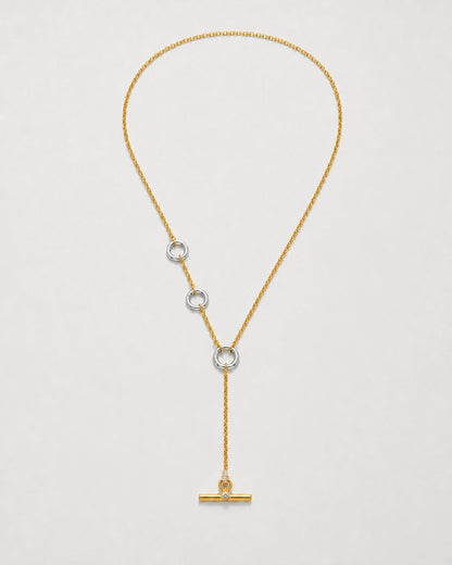 Marais mixed-metal crystal lariat necklace on seamless pale neutral grey