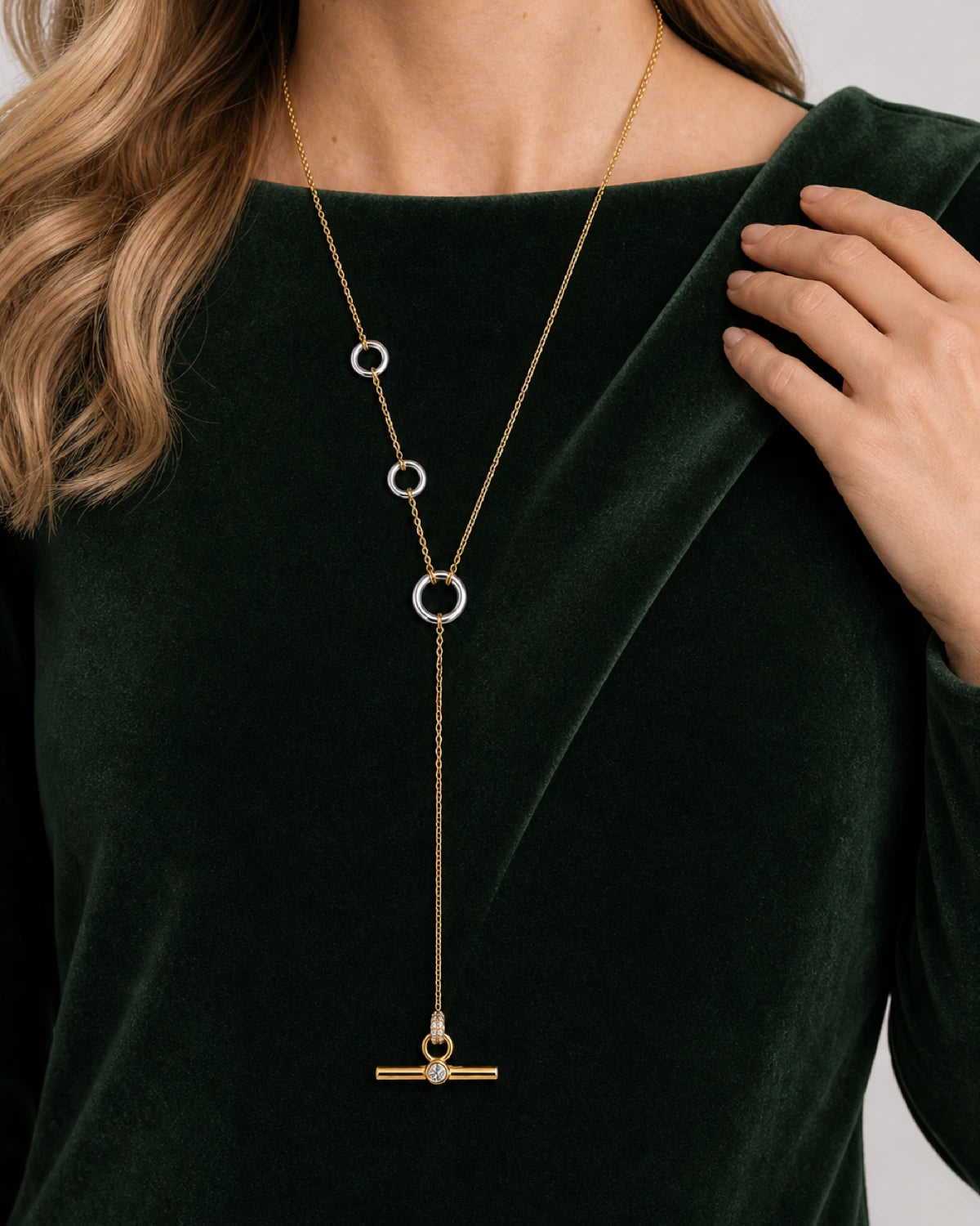 Hand and shoulder detail of Gabrielle wearing the Marais three-ring lariat