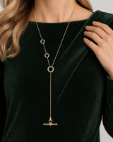 Hand and shoulder detail of Gabrielle wearing the Marais three-ring lariat
