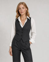 Wide grey-studio editorial portrait with the Marcelle collar necklace