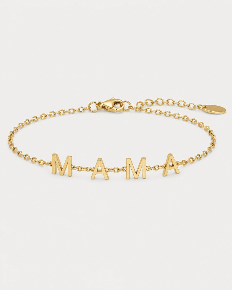 Maren gold Mama letter bracelet on a seamless pale dove-grey studio background