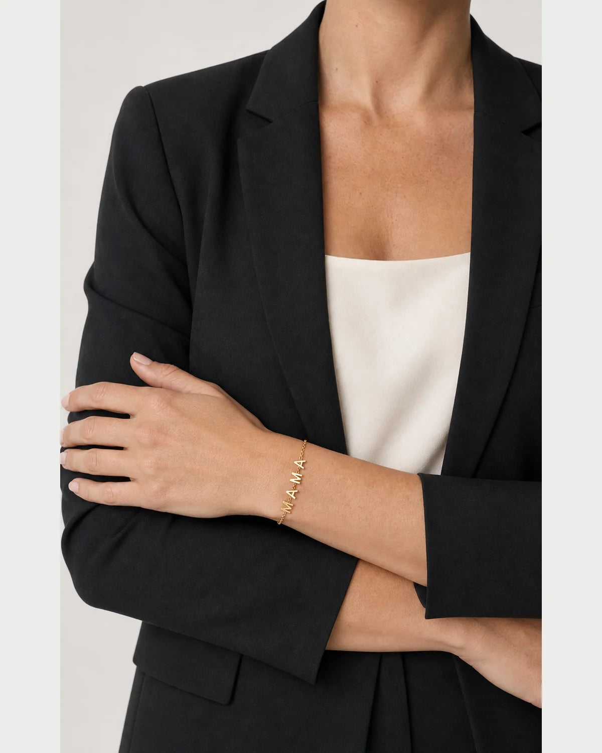 Close wrist view of the Maren bracelet with four polished M A M A letters