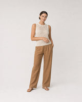 Wide studio portrait in ivory knit and caramel linen featuring the Maren bracelet