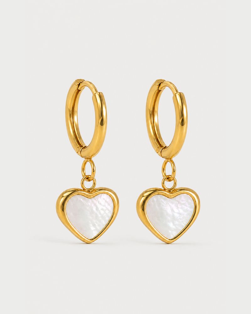 Pair of Maris gold mother-of-pearl heart huggies on a seamless pale dove-grey background