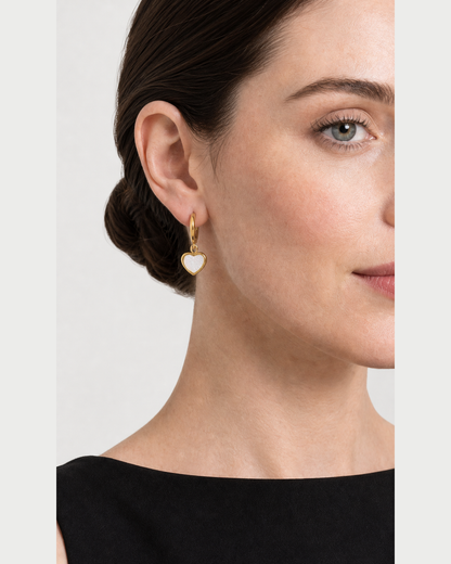 Close ear view of one Maris gold huggie and luminous mother-of-pearl heart