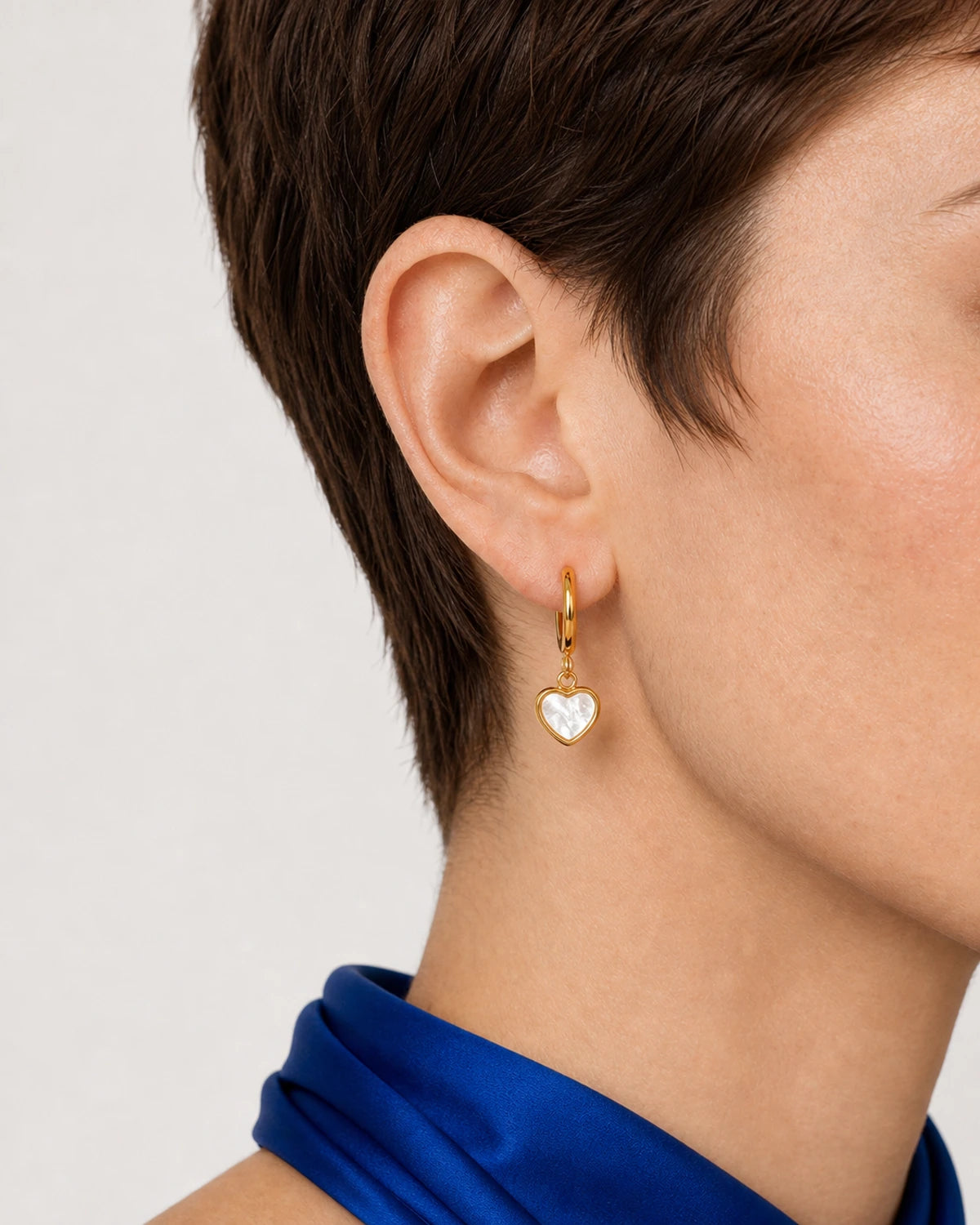 Eye-free side ear and jaw close-up wearing a complete Maris heart huggie