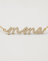Macro of the Mila lowercase mama nameplate and clear pave stones