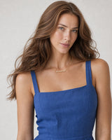 Model in a cobalt-blue linen summer dress wearing the Mila pave Mama necklace