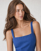 Alternate European-summer portrait featuring the Mila gold Mama necklace