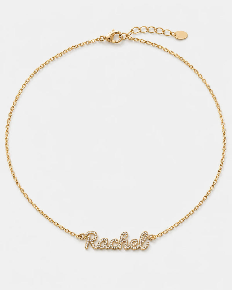Mira gold pavé Rachel name necklace on pale dove-grey