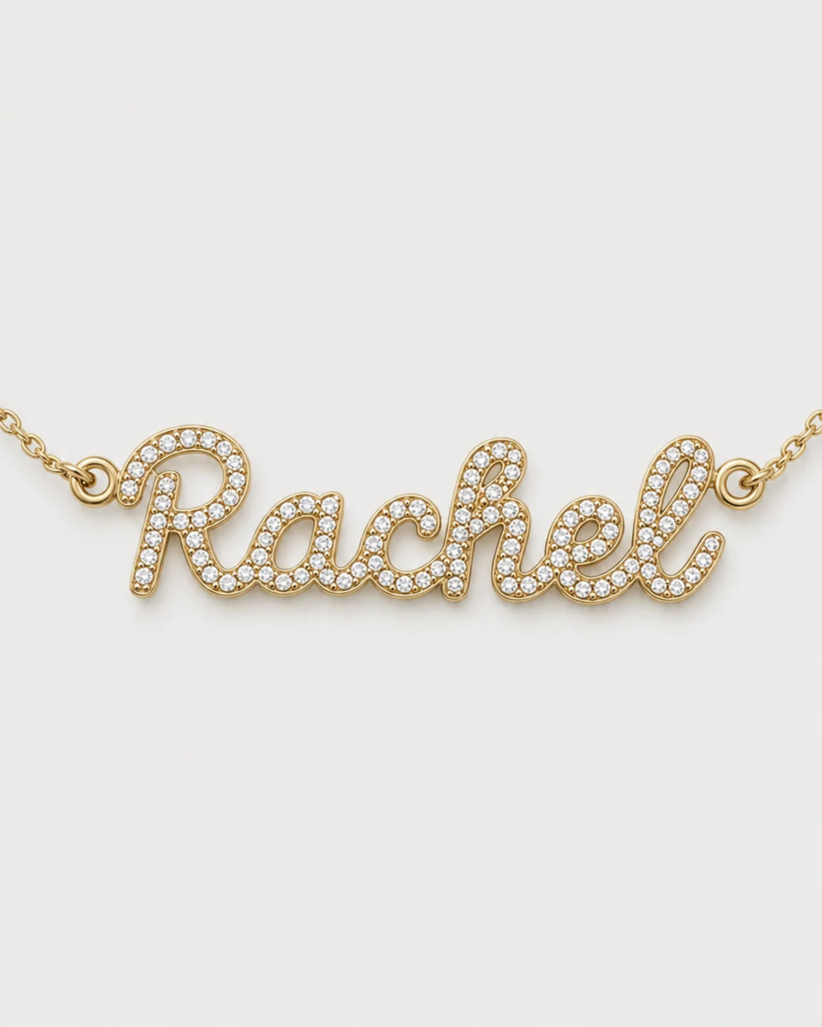 Macro of the Mira connected cursive Rachel nameplate and micro-pavé stones