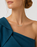 Left three-quarter chin-down portrait wearing the gold Mira pavé Rachel necklace
