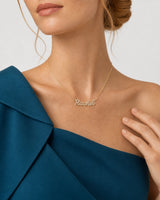 Close wearing view of the gold Mira pavé Rachel necklace with a natural hand pose