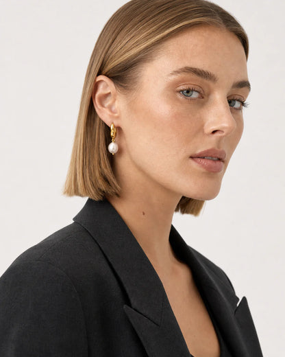 Australian model in charcoal tailoring wearing Mirelle earrings