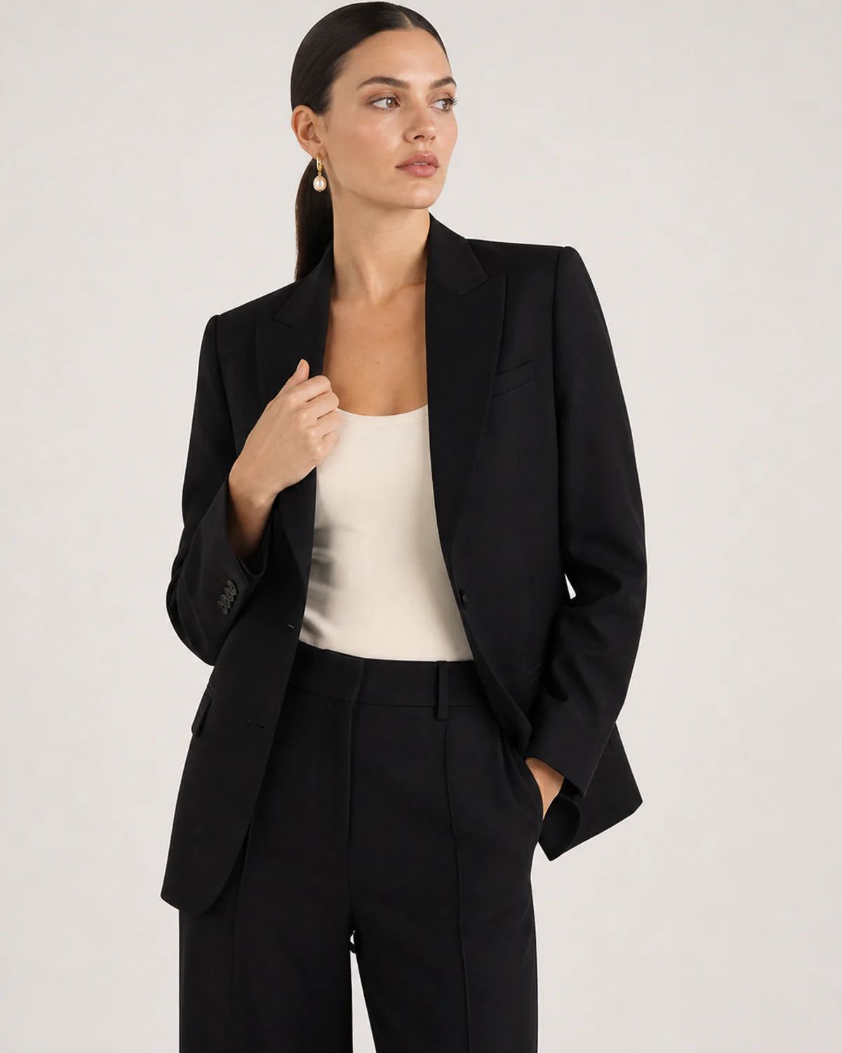 Wide grey-studio portrait featuring Mirelle pearl drop earrings
