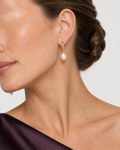 Tight ear and jawline view of a complete Mirelle pearl drop earring