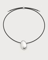 Naiya silver pebble cord necklace on a seamless pale dove-grey studio background