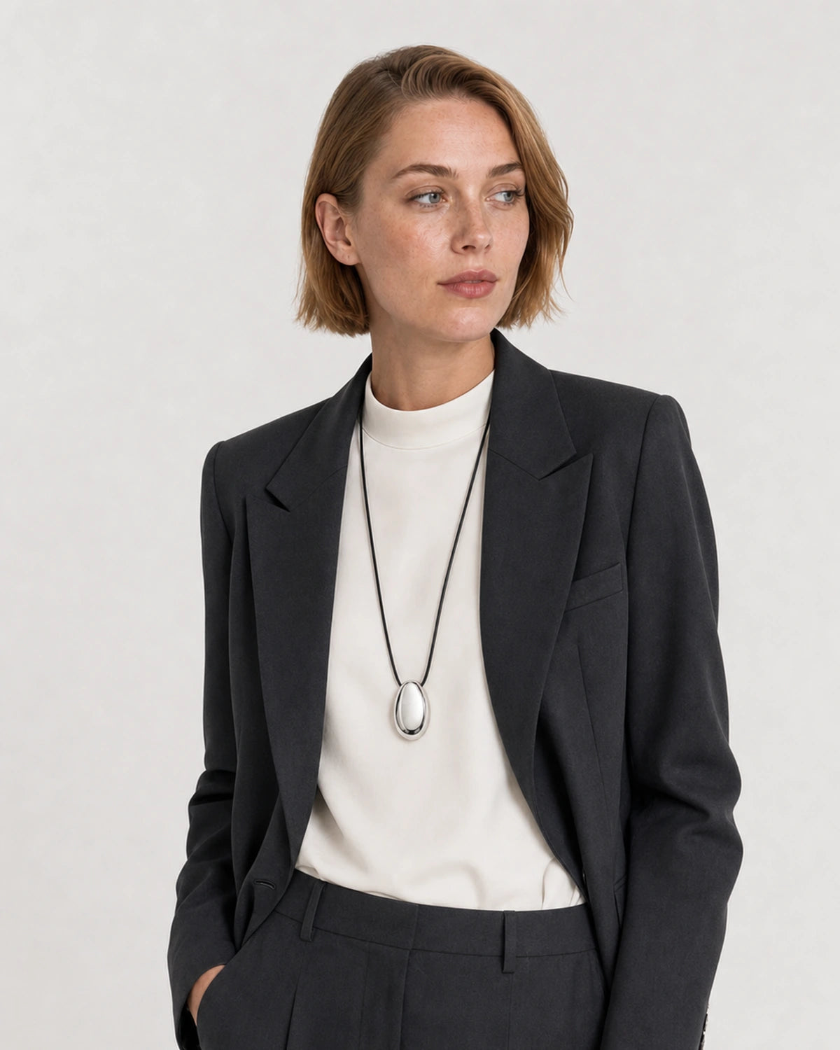 Alternate portrait of the same American model wearing the Naiya silver cord necklace