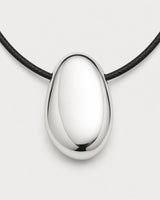 Macro front detail of the Naiya mirror-silver pebble and side-threaded black cord