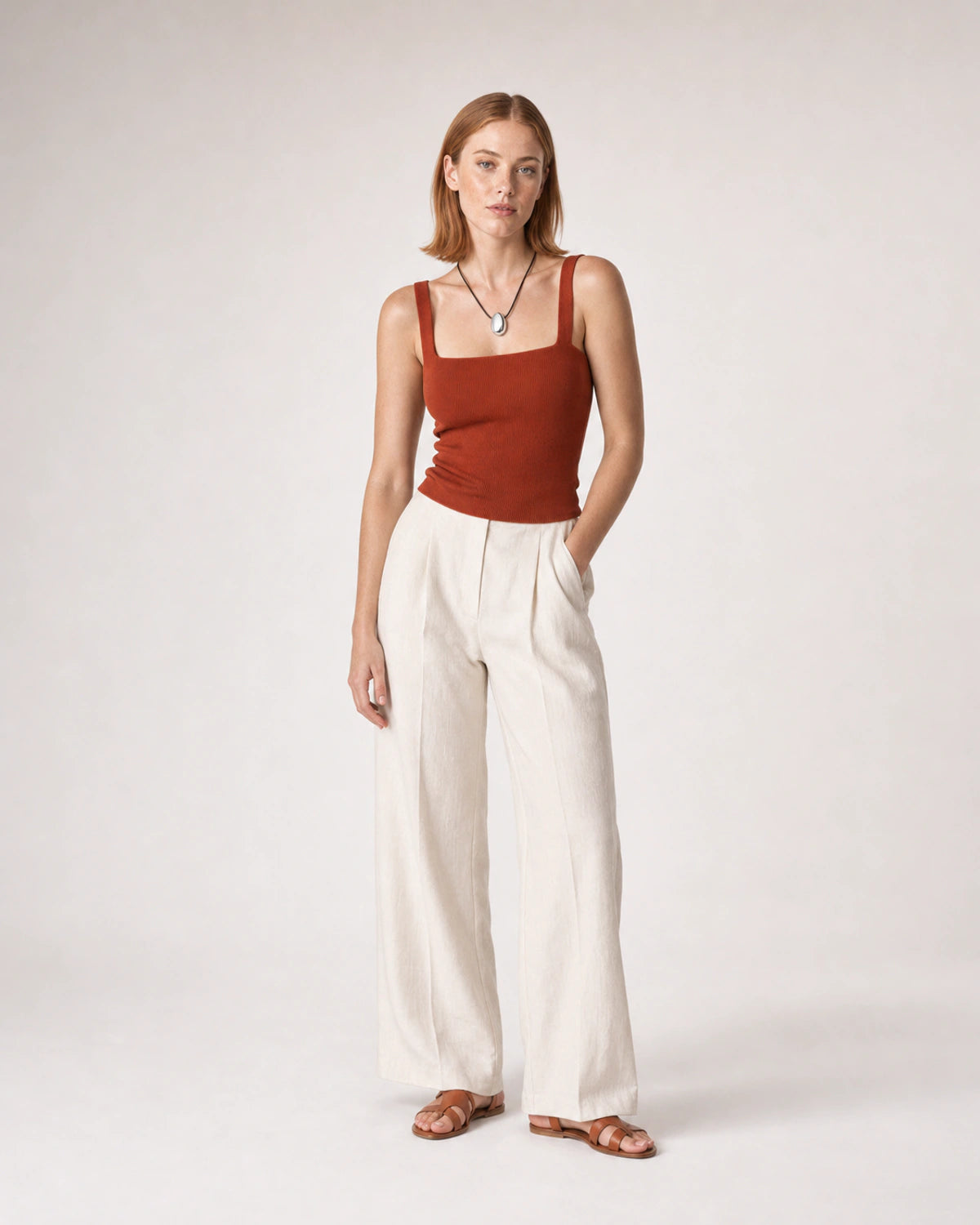 Wide studio portrait in terracotta knit and ivory linen featuring the Naiya necklace