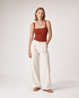 Wide studio portrait in terracotta knit and ivory linen featuring the Naiya necklace