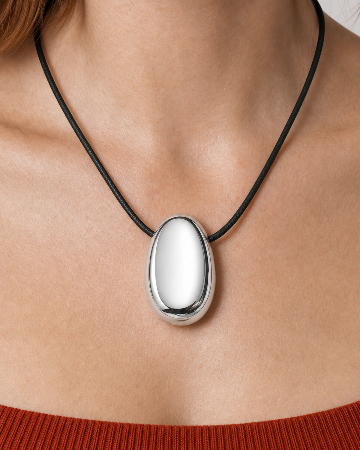 Extreme on-body macro of the Naiya mirror-silver pebble and direct side threading