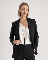 Human-scale studio view of the Nera bead tassel necklace worn with black tailoring